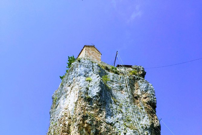 Chiatura and Katskhi Pillar One Day Urbex Tour - Mgvimevi Monastery and its cliffside setting